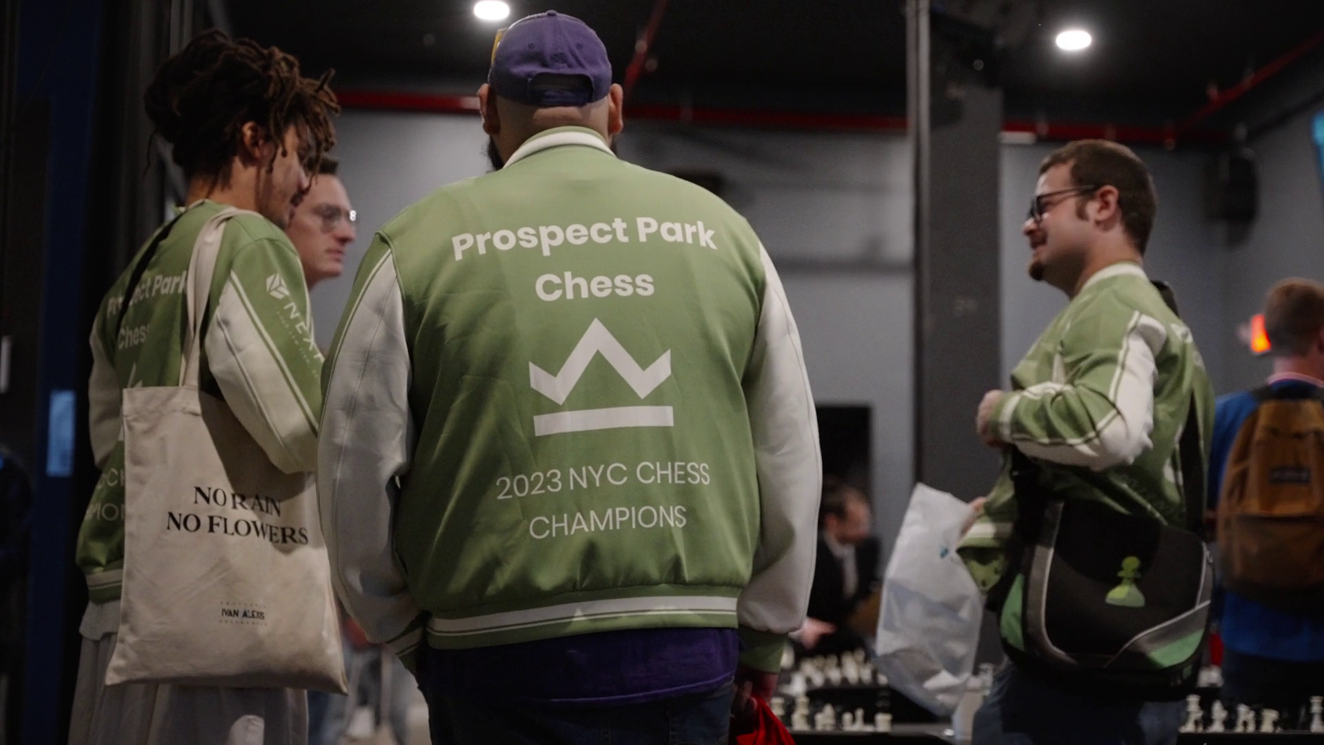 Players in Prospect Park Chess team jackets between rounds