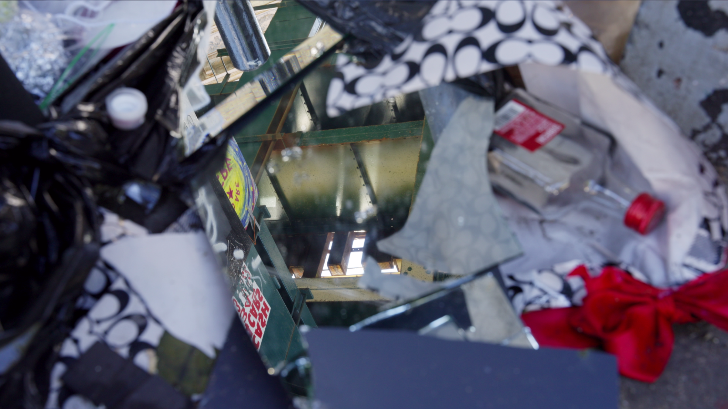 Macro abstract of a shattered mirror reflecting the elevated train